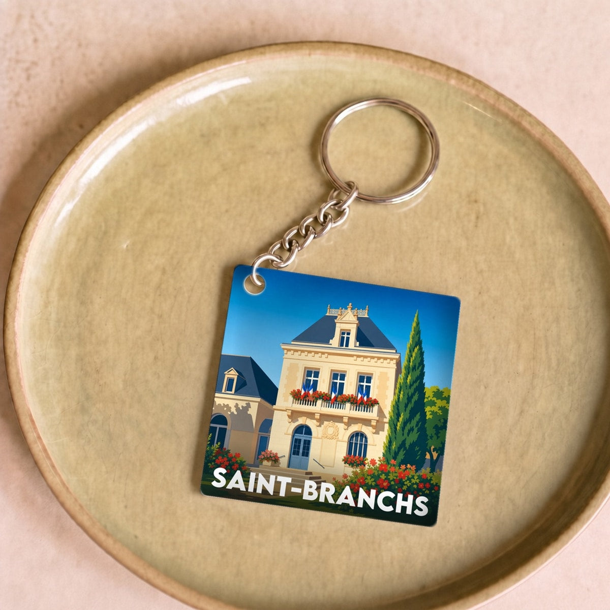 Porte-clés souvenir de la ville de Saint-Branchs avec une illustration stylisée.