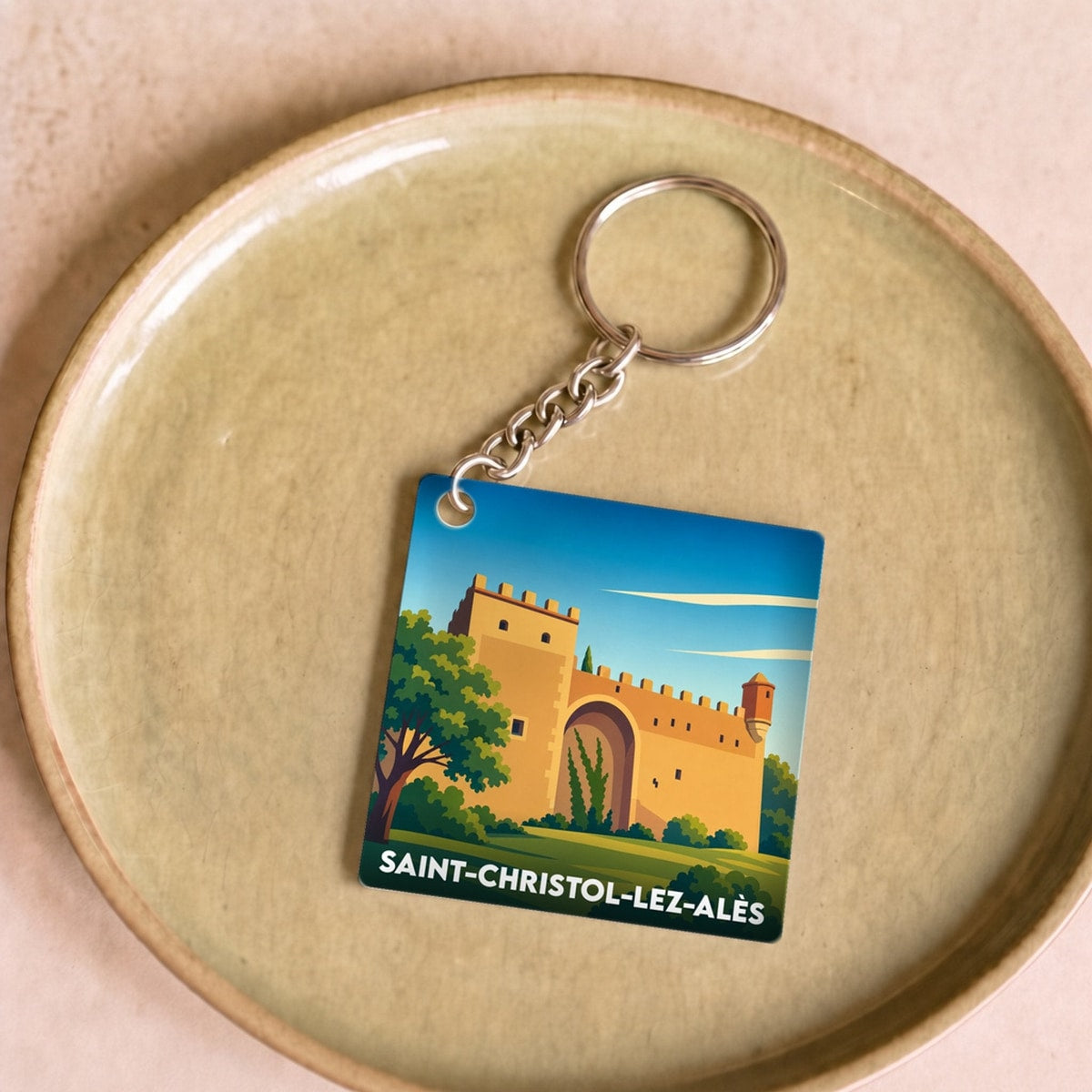 Porte-clés souvenir de la ville de Saint-Christol-lez-Alès avec une illustration stylisée.