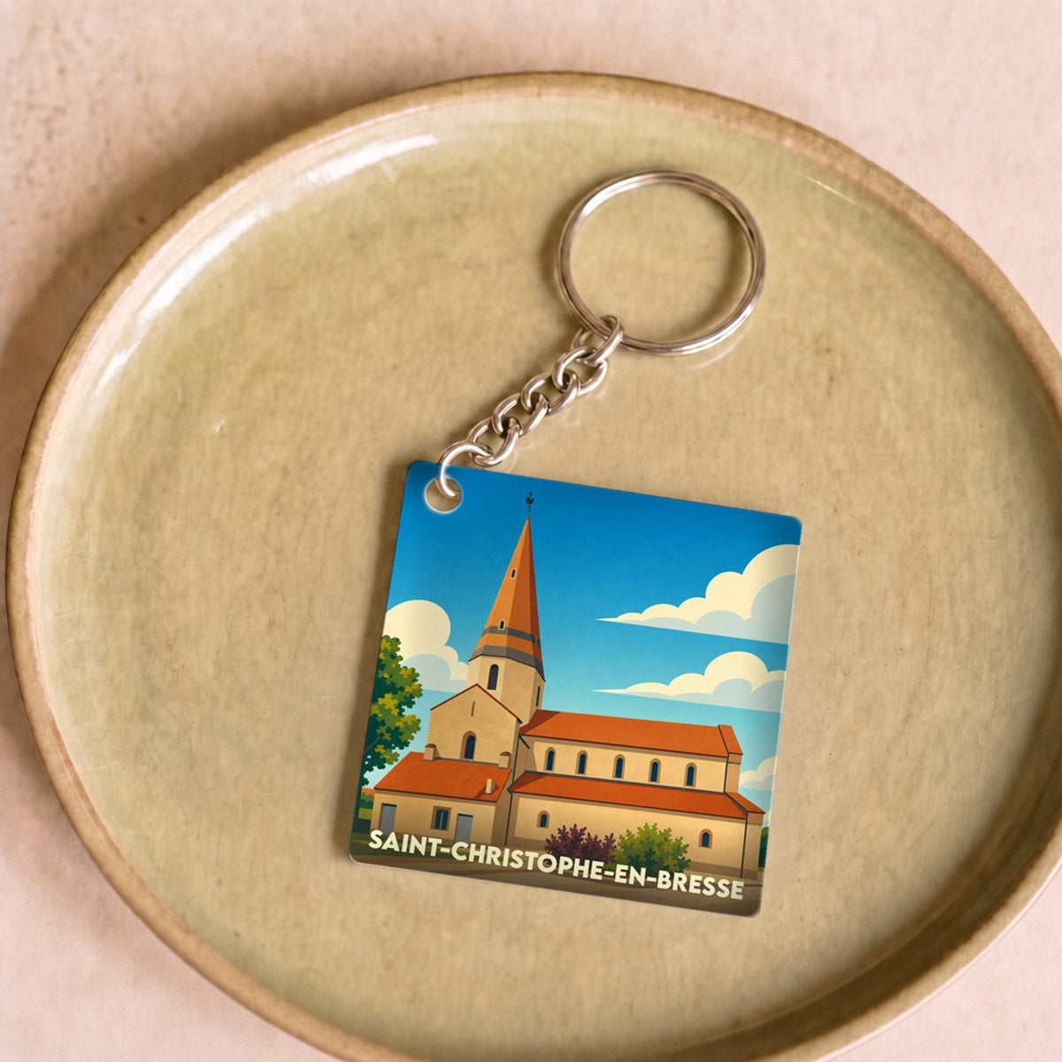 Porte-clés souvenir de Saint-Christophe-en-Bresse avec une illustration stylisée de son église.
