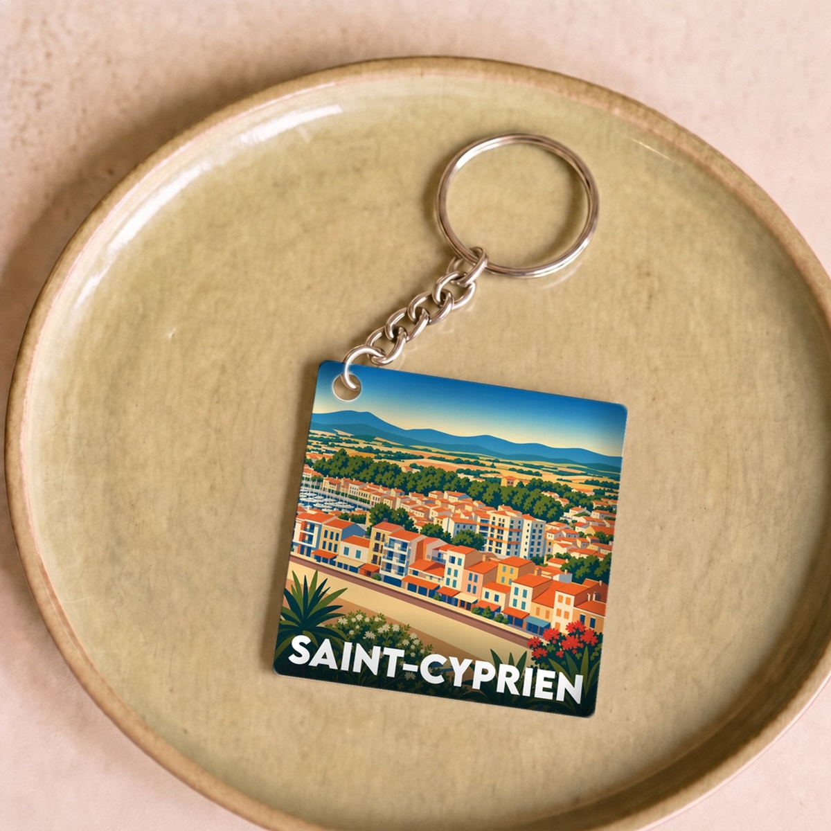 Porte-clés souvenir de la ville de Saint-Cyprien avec une illustration stylisée.