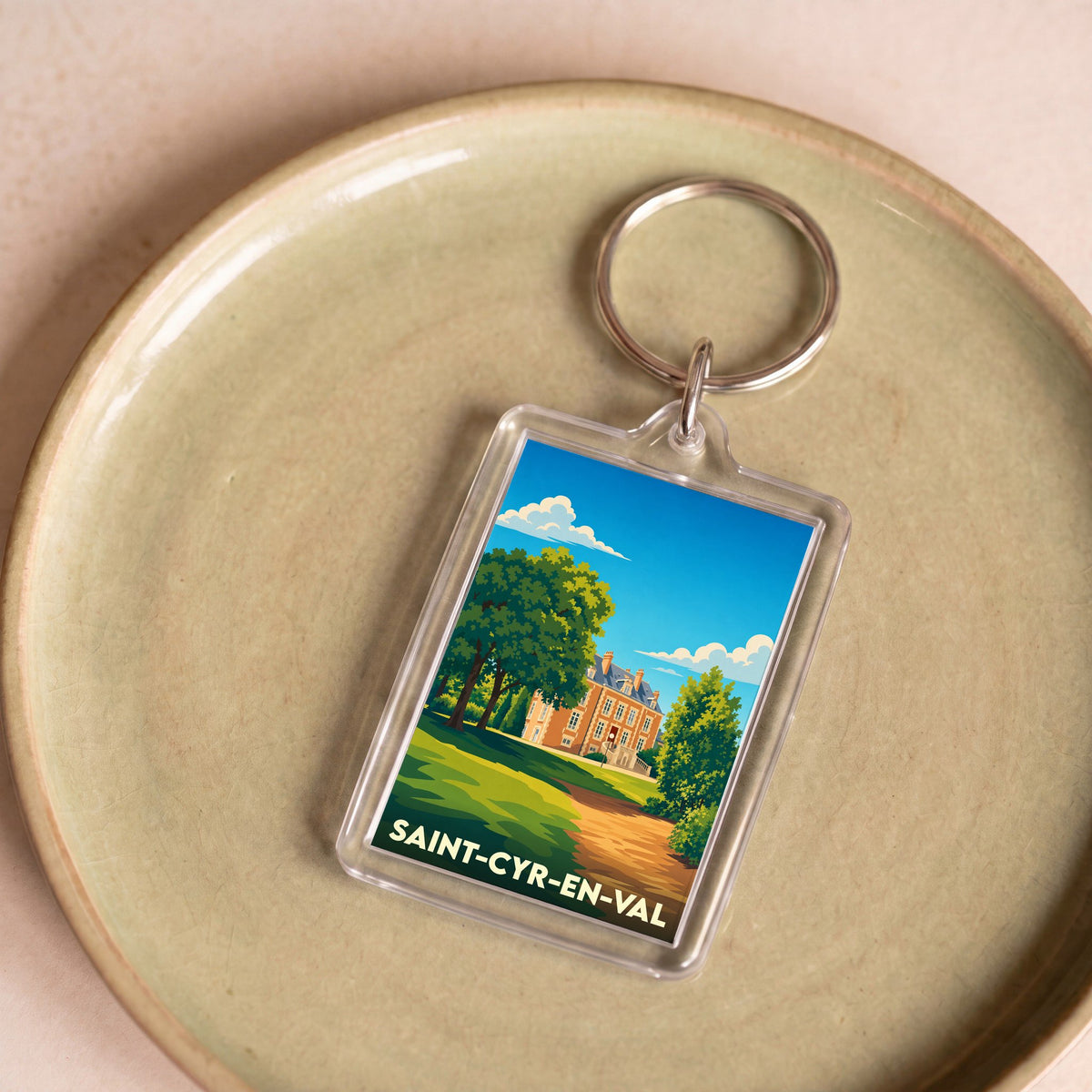 Porte-clés souvenir de la ville de Saint-Cyr-en-Val avec une illustration stylisée de son château.