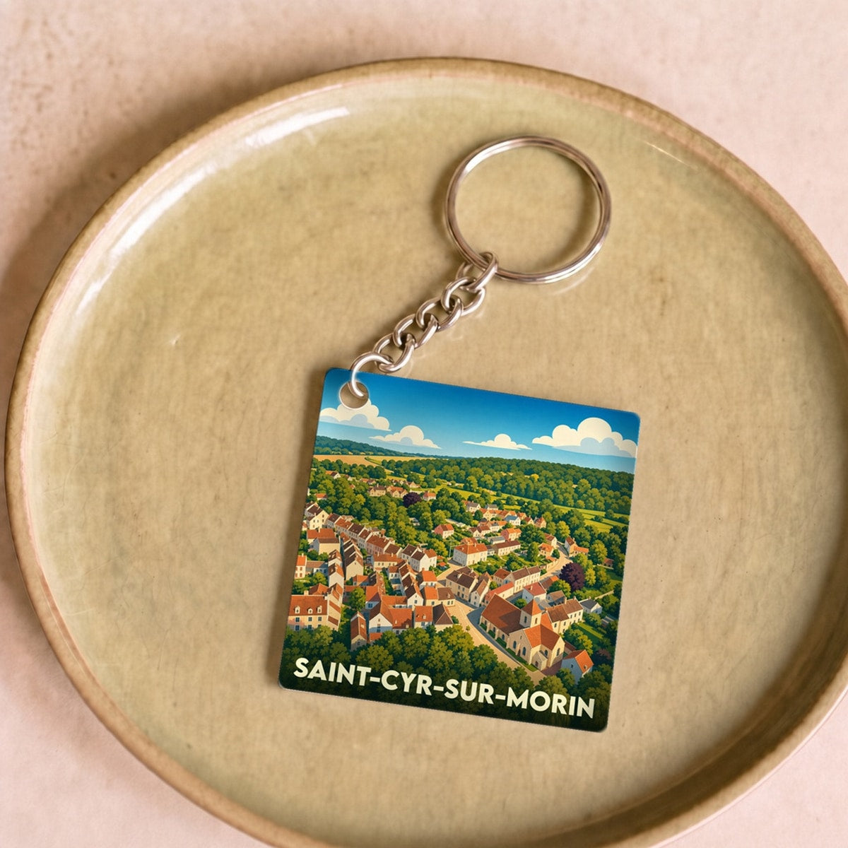 Porte-clés souvenir de la ville de Saint-Cyr-sur-Morin avec une illustration stylisée.
