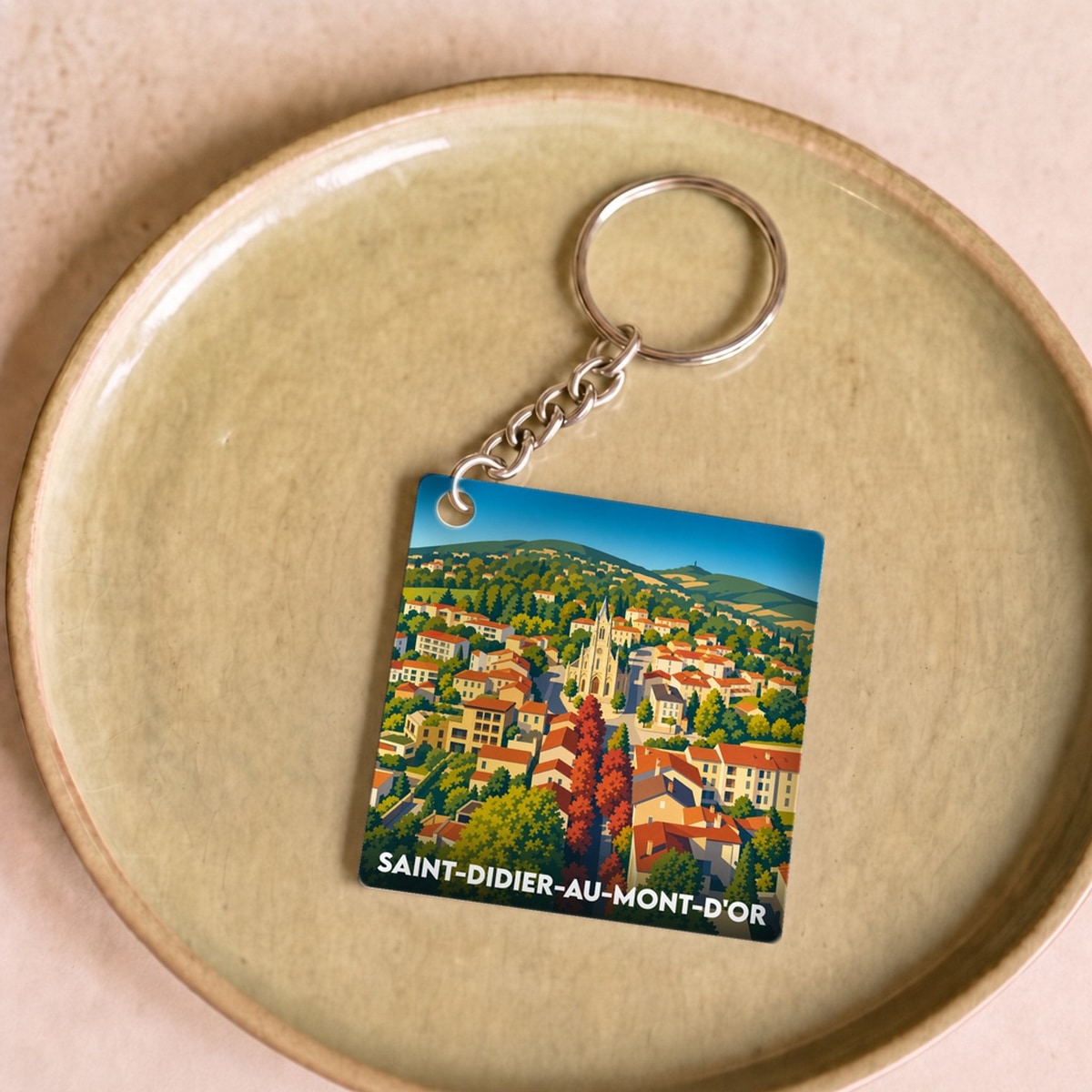 Porte-clés souvenir de la ville de Saint-Didier-au-Mont-d'Or avec une illustration stylisée.