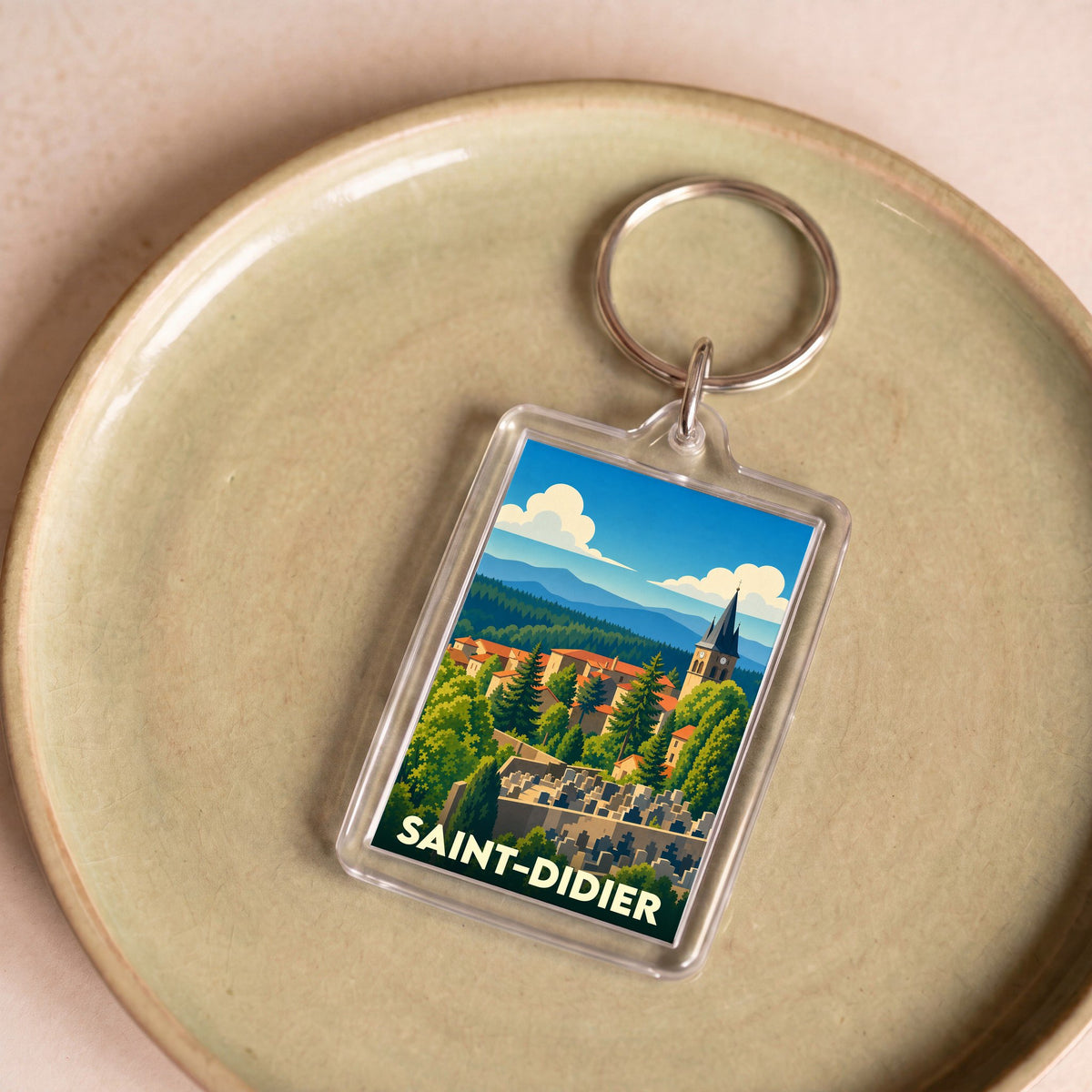 Porte-clés souvenir de la ville de Saint-Didier avec une illustration stylisée.