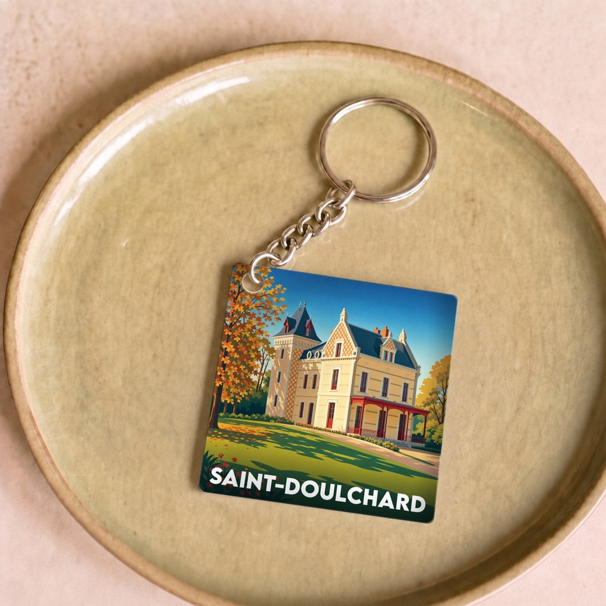 Porte-clés souvenir de la ville de Saint-Doulchard avec une illustration stylisée d'un château.