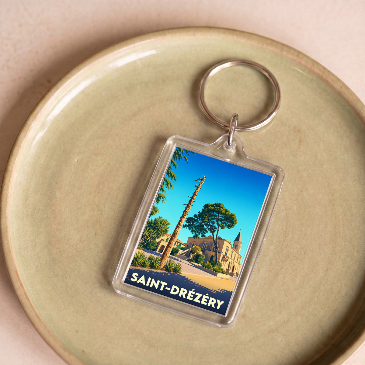 Porte-clés souvenir de la ville de Saint-Drézéry avec une illustration stylisée.