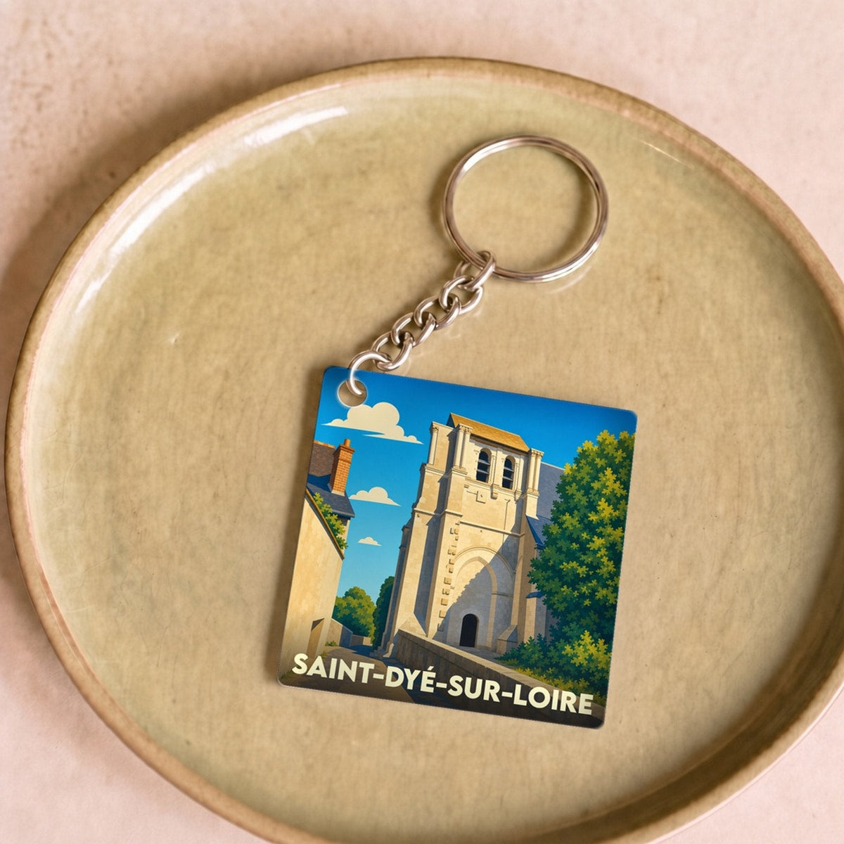 Porte-clés souvenir de la ville de Saint-Dyé-sur-Loire avec une illustration stylisée.
