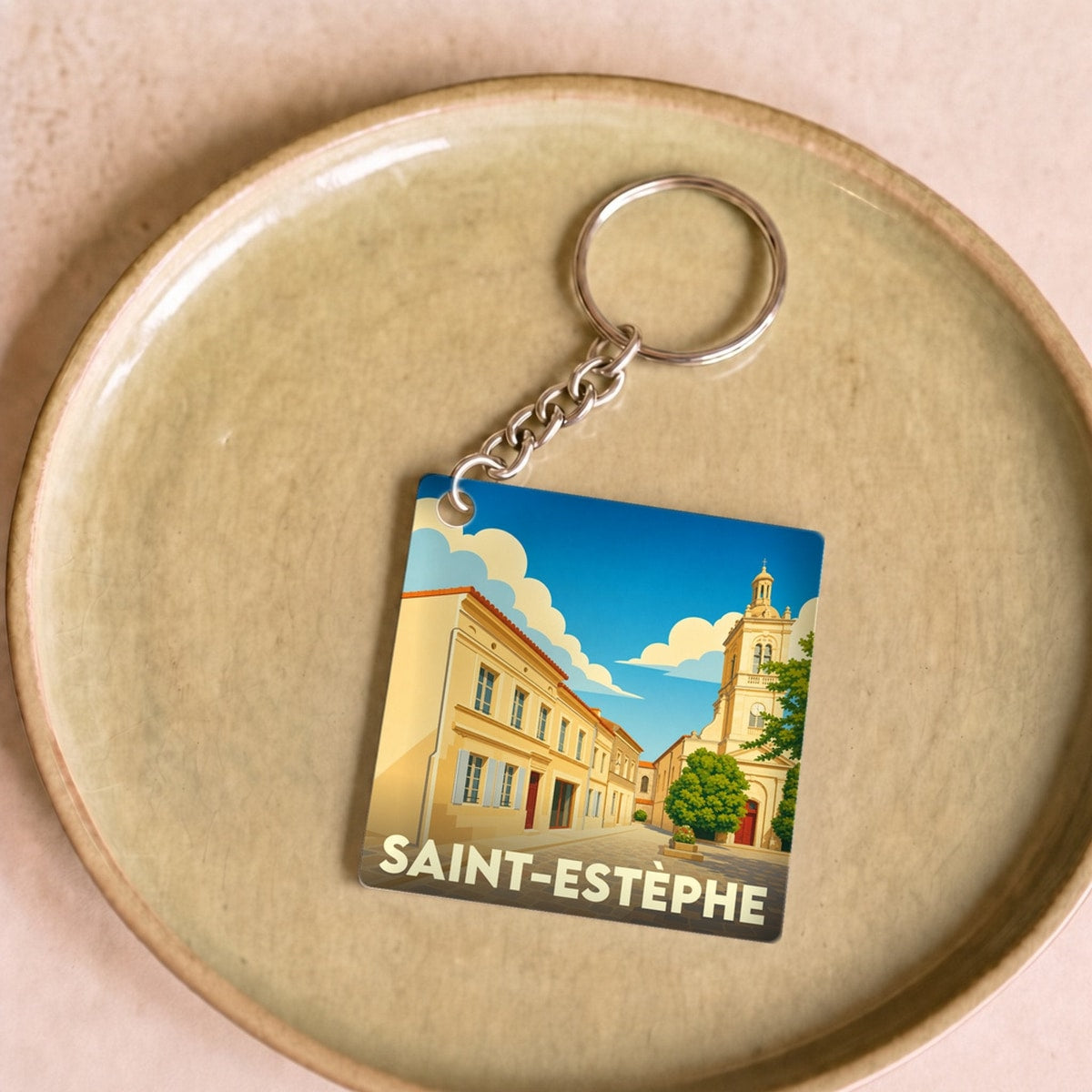 Porte-clés souvenir de la ville de Saint-Estèphe avec une illustration stylisée.