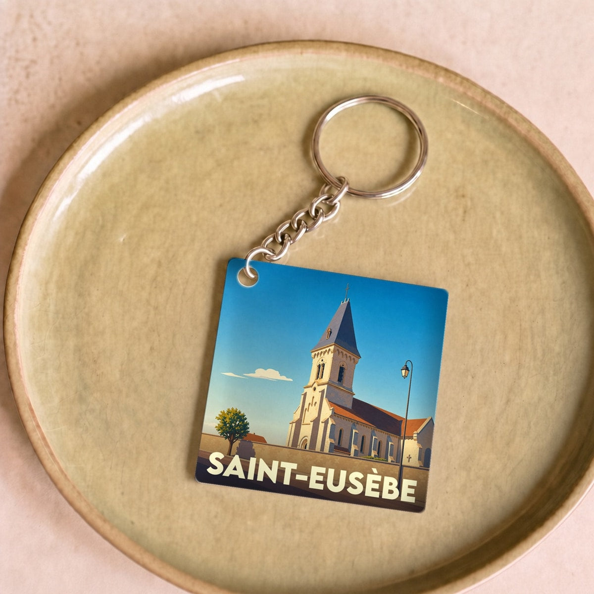 Porte-clés souvenir de la ville de Saint-Eusèbe avec une illustration stylisée de son église.
