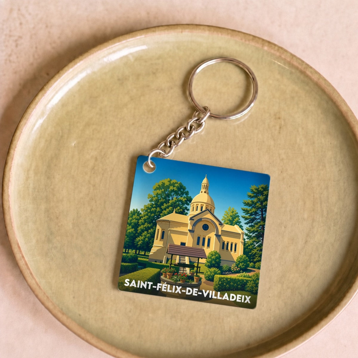 Porte-clés souvenir de la ville de Saint-Félix-de-Villadeix avec une illustration stylisée.
