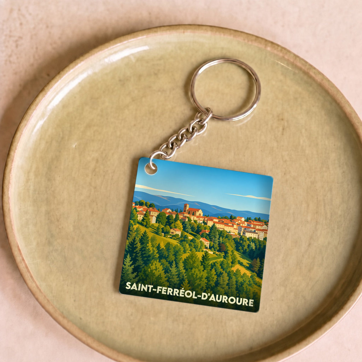 Porte-clés souvenir de la ville de Saint-Ferréol-d'Auroure avec une illustration stylisée.