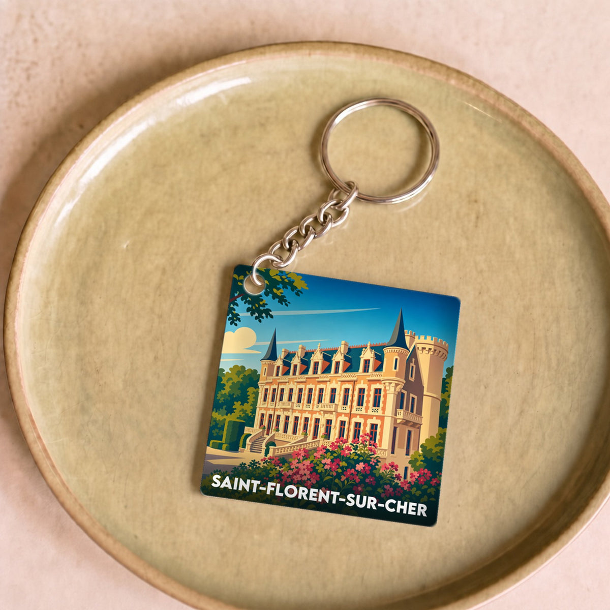 Porte-clés souvenir de la ville de Saint-Florent-sur-Cher avec une illustration stylisée de son château.