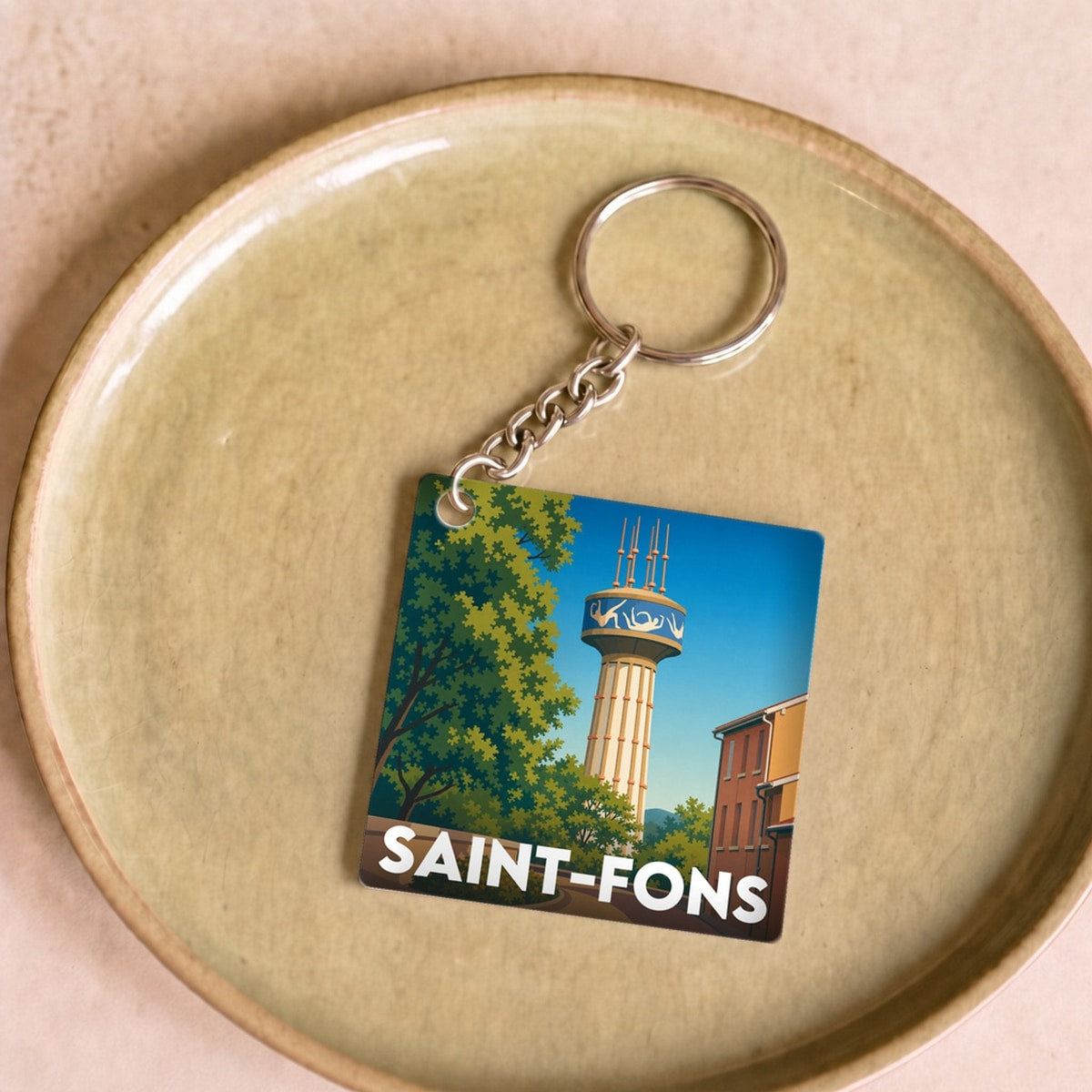 Porte-clés souvenir de la ville de Saint-Fons avec une illustration stylisée.
