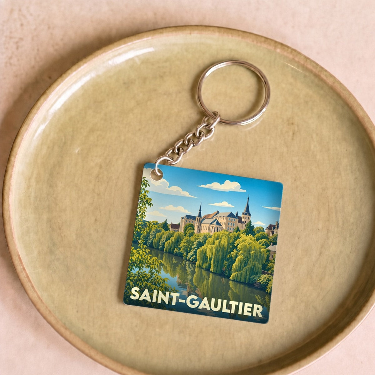 Porte-clés souvenir de la ville de Saint-Gaultier avec une illustration stylisée.