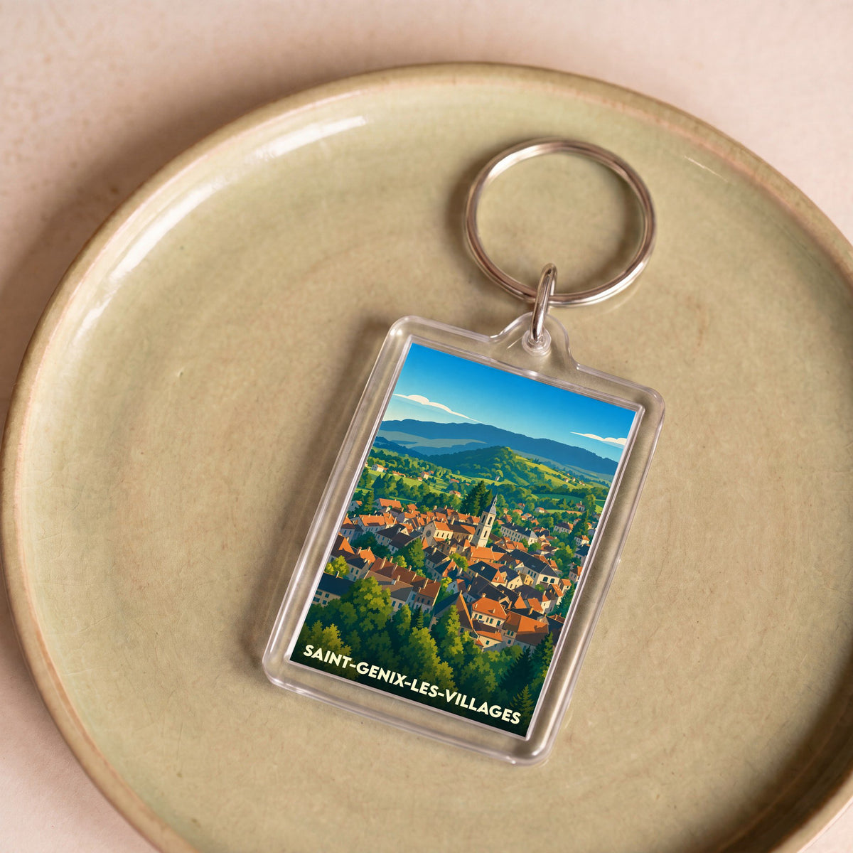Porte-clés souvenir de la ville de Saint-Genix-les-Villages avec une illustration stylisée.
