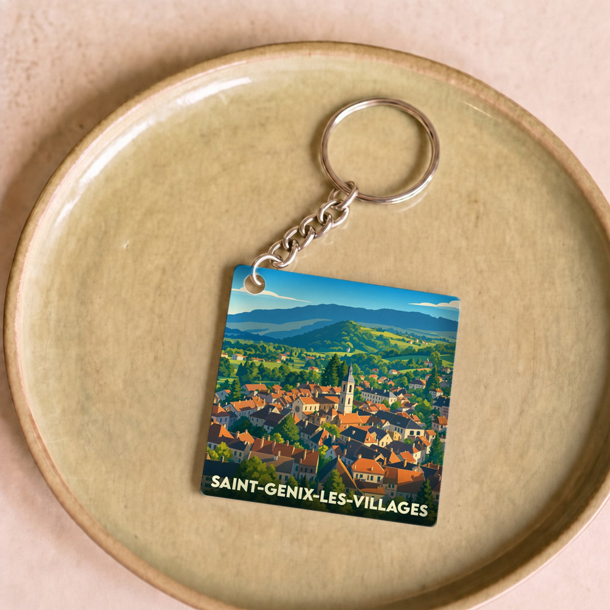 Porte-clés souvenir de la ville de Saint-Genix-les-Villages avec une illustration stylisée.