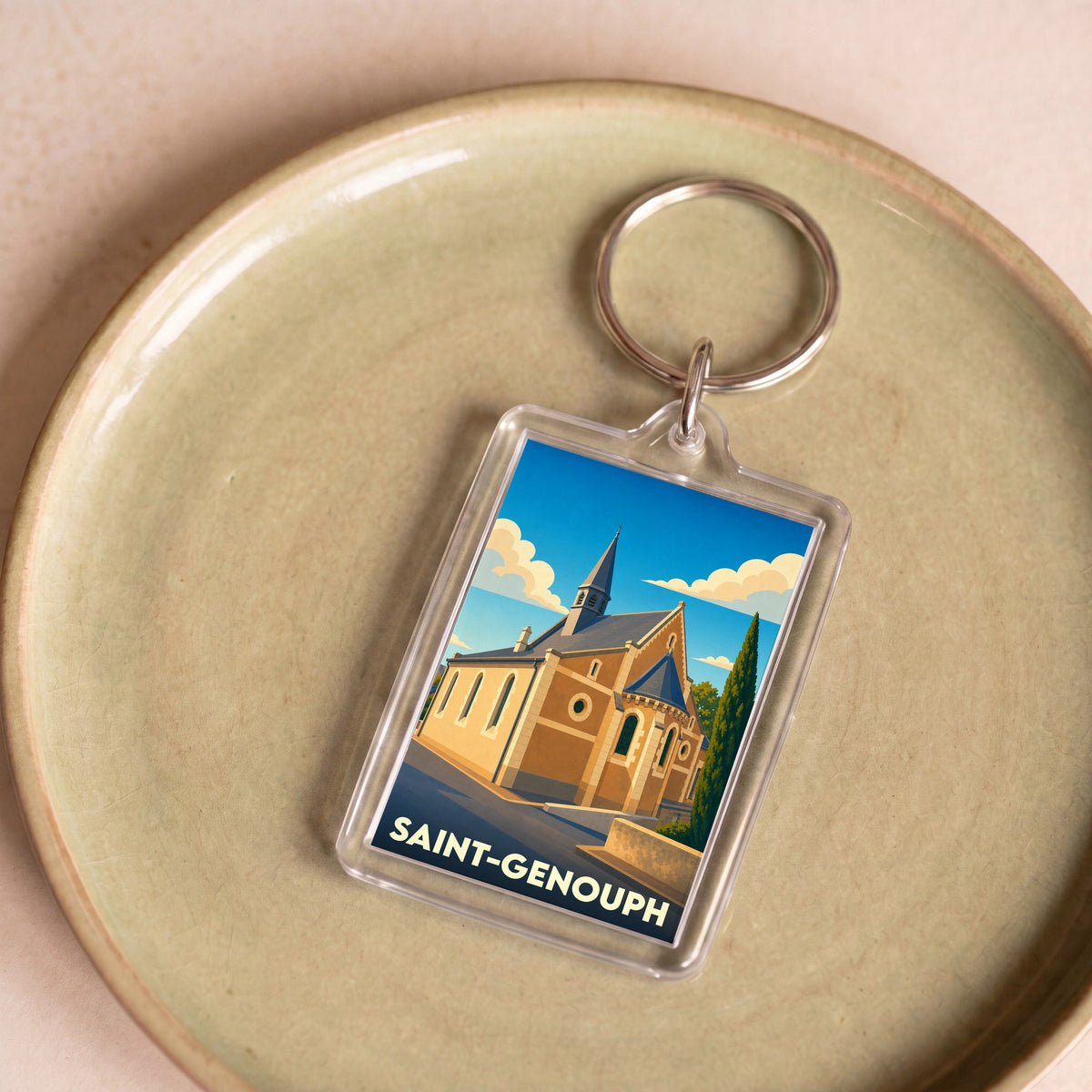 Porte-clés souvenir de la ville de Saint-Genouph avec une illustration stylisée d'une église.