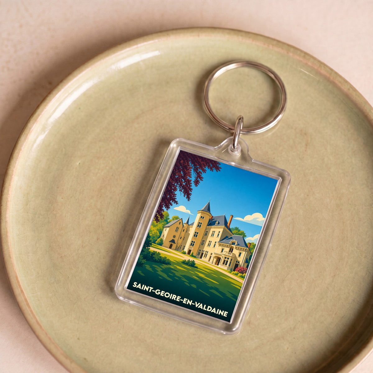 Porte-clés souvenir de la ville de Saint-Geoire-en-Valdaine avec une illustration stylisée d'un château.