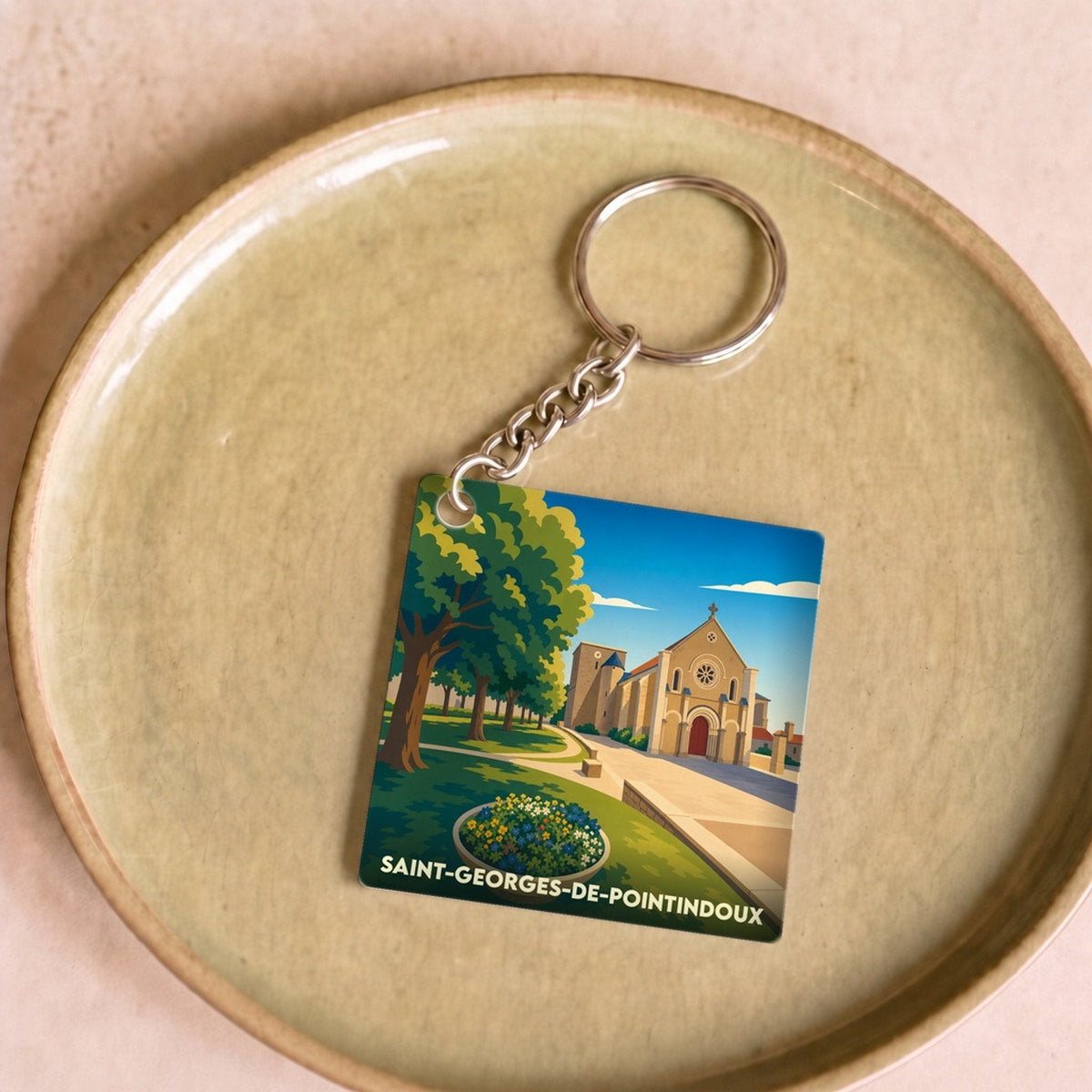 Porte-clés souvenir de la ville de Saint-Georges-de-Pointindoux avec une illustration stylisée.