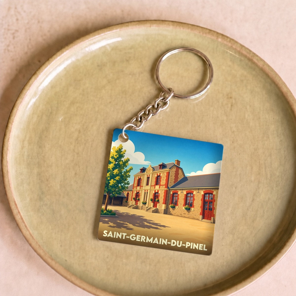 Porte-clés souvenir de Saint-Germain-du-Pinel avec une illustration stylisée.
