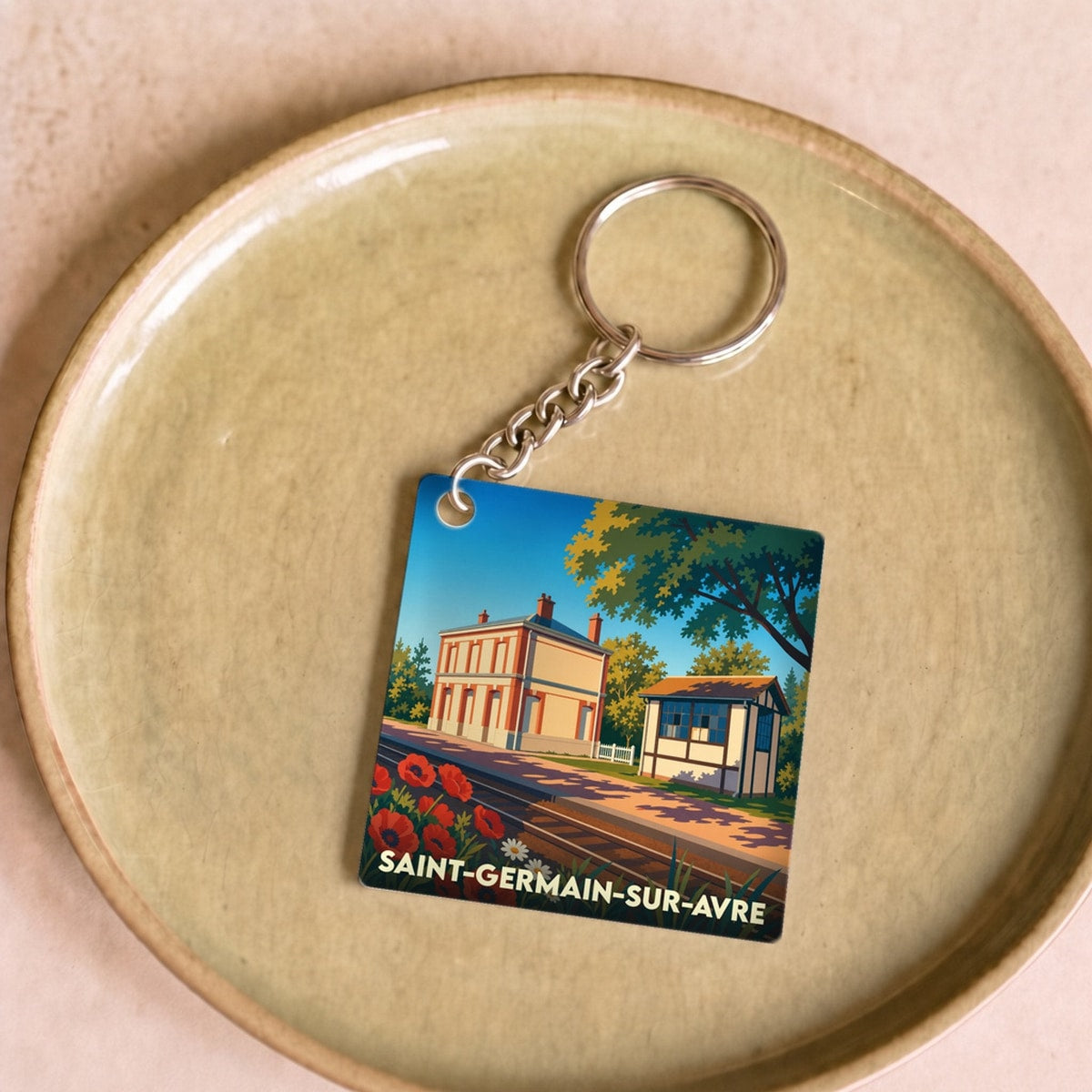 Porte-clés souvenir de la ville de Saint-Germain-sur-Avre avec une illustration stylisée.