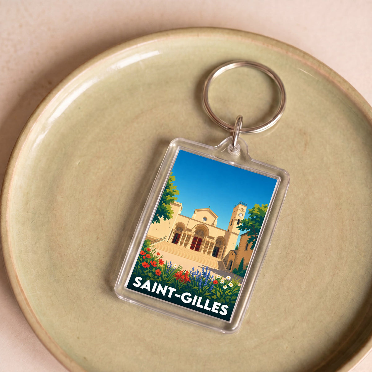 Porte-clés souvenir de la ville de Saint-Gilles avec une illustration stylisée.