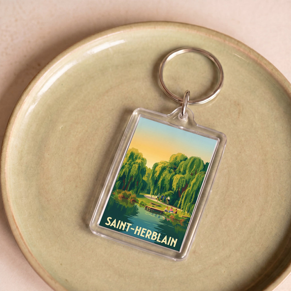 Porte-clés souvenir de la ville de Saint-Herblain avec une illustration stylisée.
