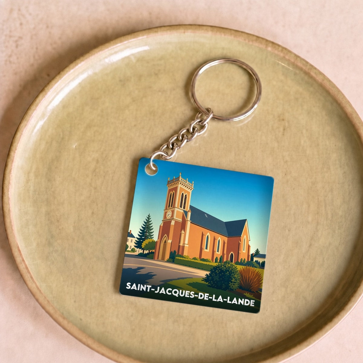 Porte-clés souvenir de la ville de Saint-Jacques-de-la-Lande avec une illustration stylisée.