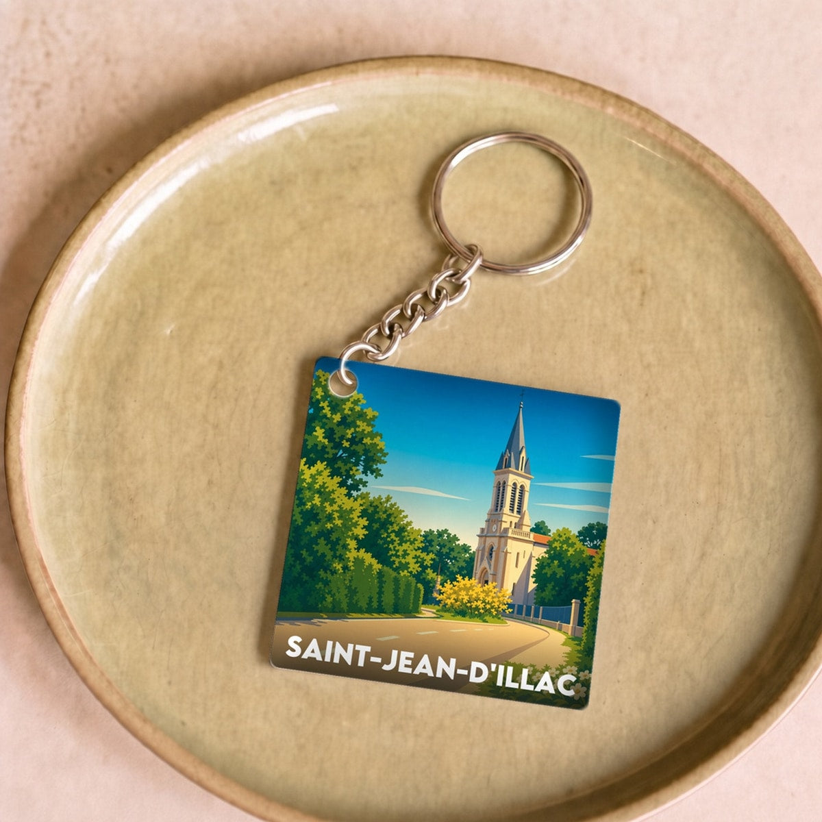 Porte-clés souvenir de la ville de Saint-Jean-d'Illac avec une illustration stylisée.