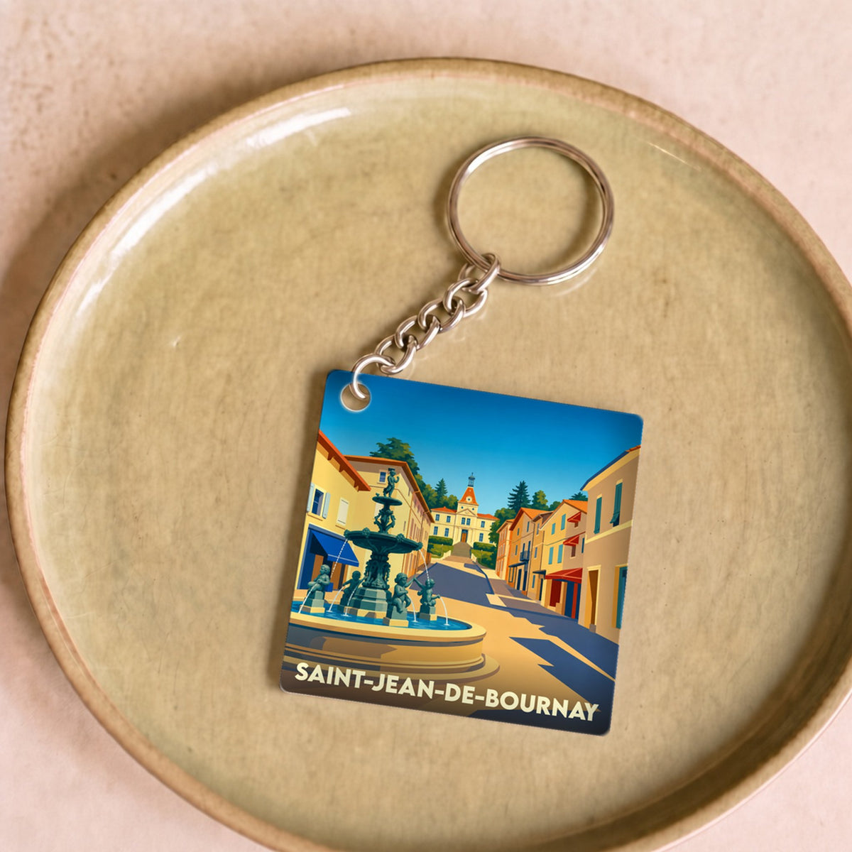 Porte-clés souvenir de la ville de Saint-Jean-de-Bournay avec une illustration stylisée.