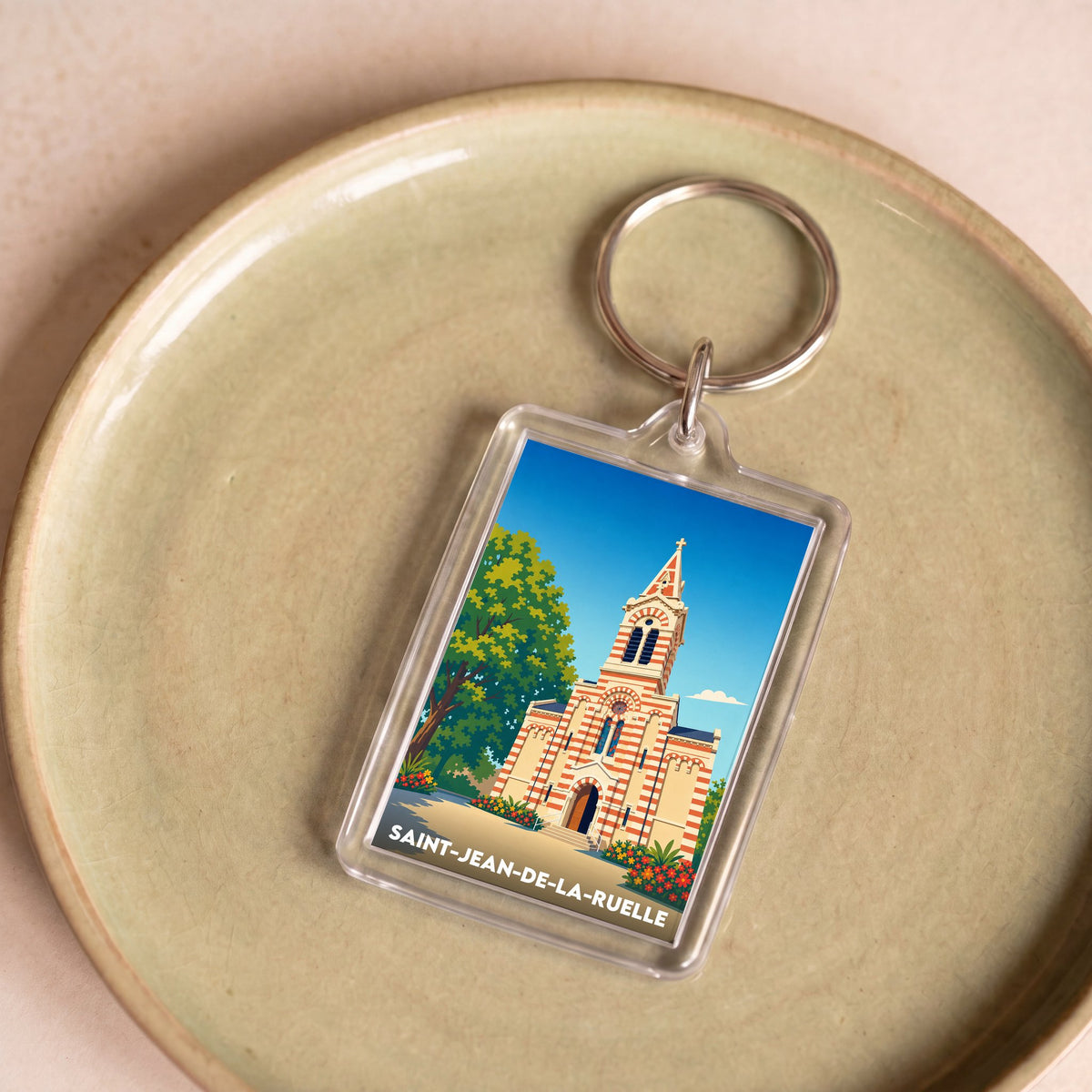 Porte-clés souvenir de la ville de Saint-Jean-de-la-Ruelle avec une illustration stylisée de son église.
