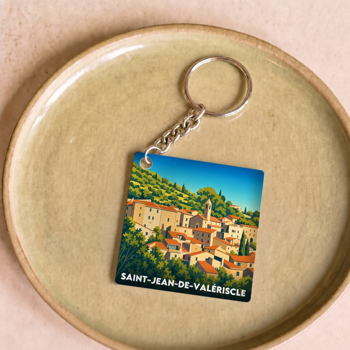 Porte-clés souvenir de la ville de Saint-Jean-de-Valériscle avec une illustration stylisée.