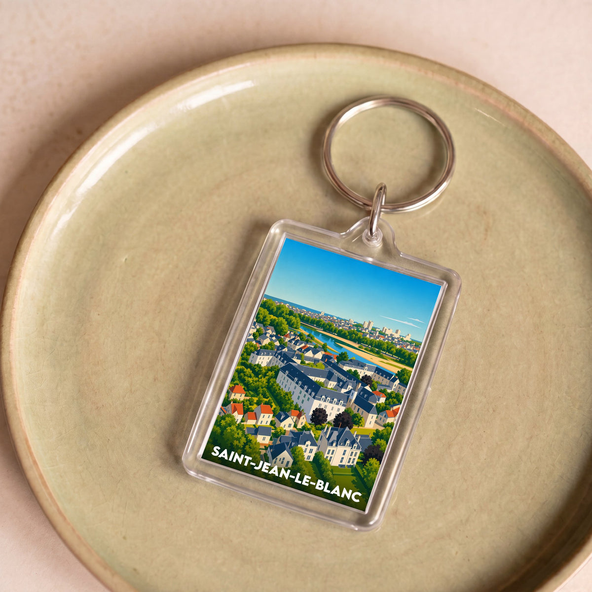 Porte-clés souvenir de la ville de Saint-Jean-le-Blanc avec une illustration aérienne colorée.