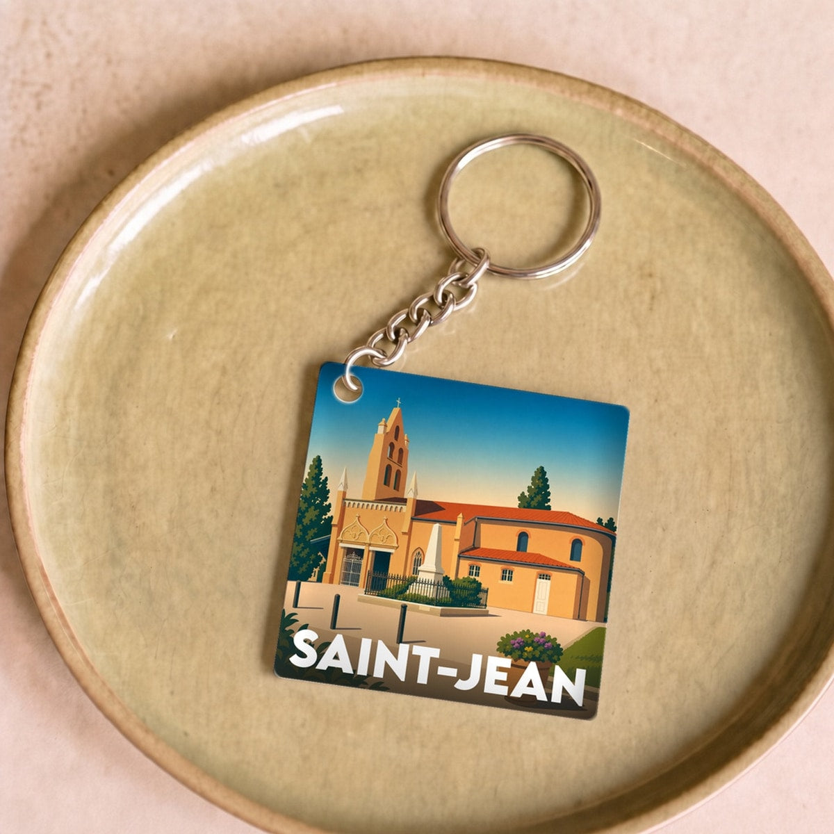 Porte-clés souvenir de la ville de Saint-Jean avec une illustration stylisée.