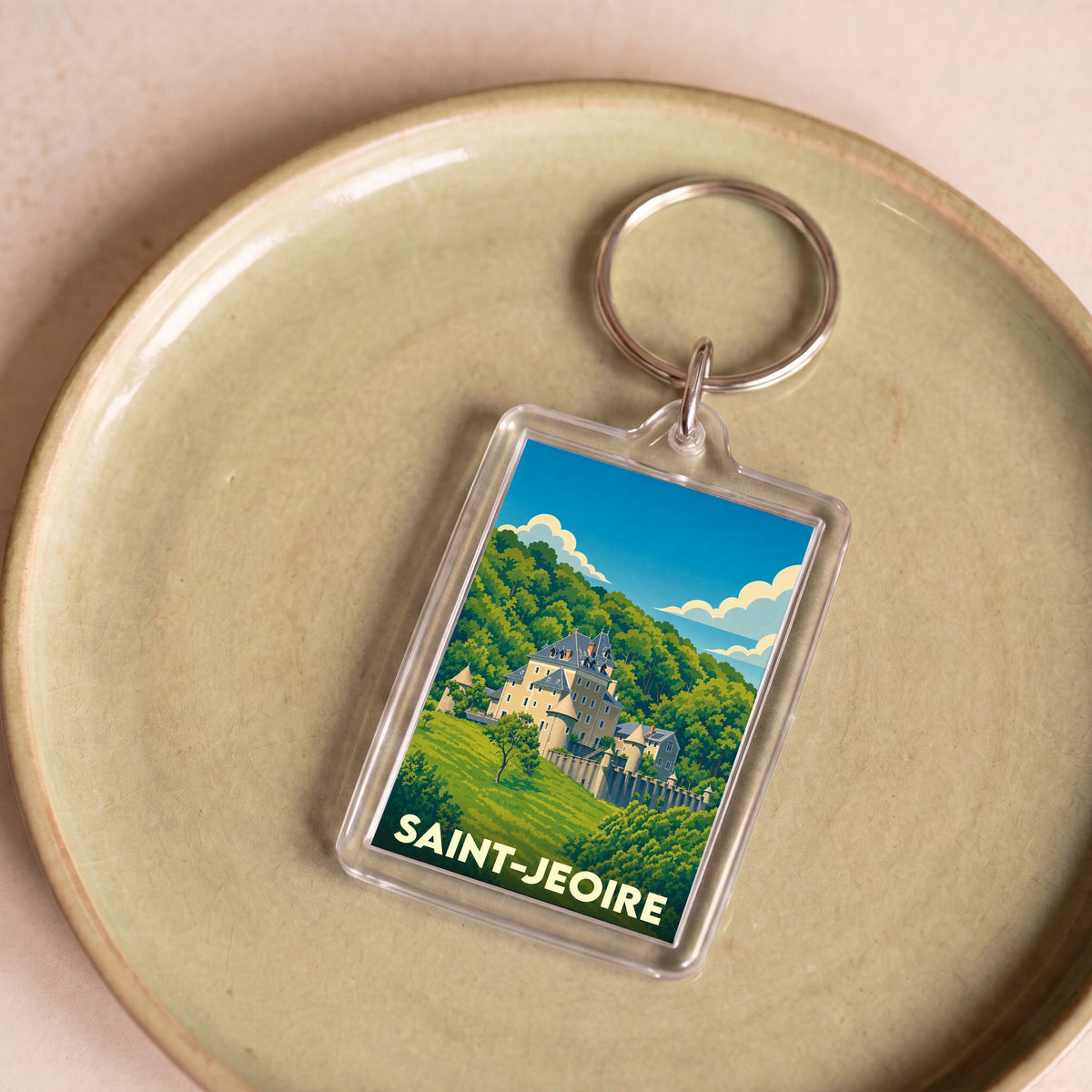 Porte-clés souvenir de la ville de Saint-Jeoire avec une illustration stylisée d'un château.