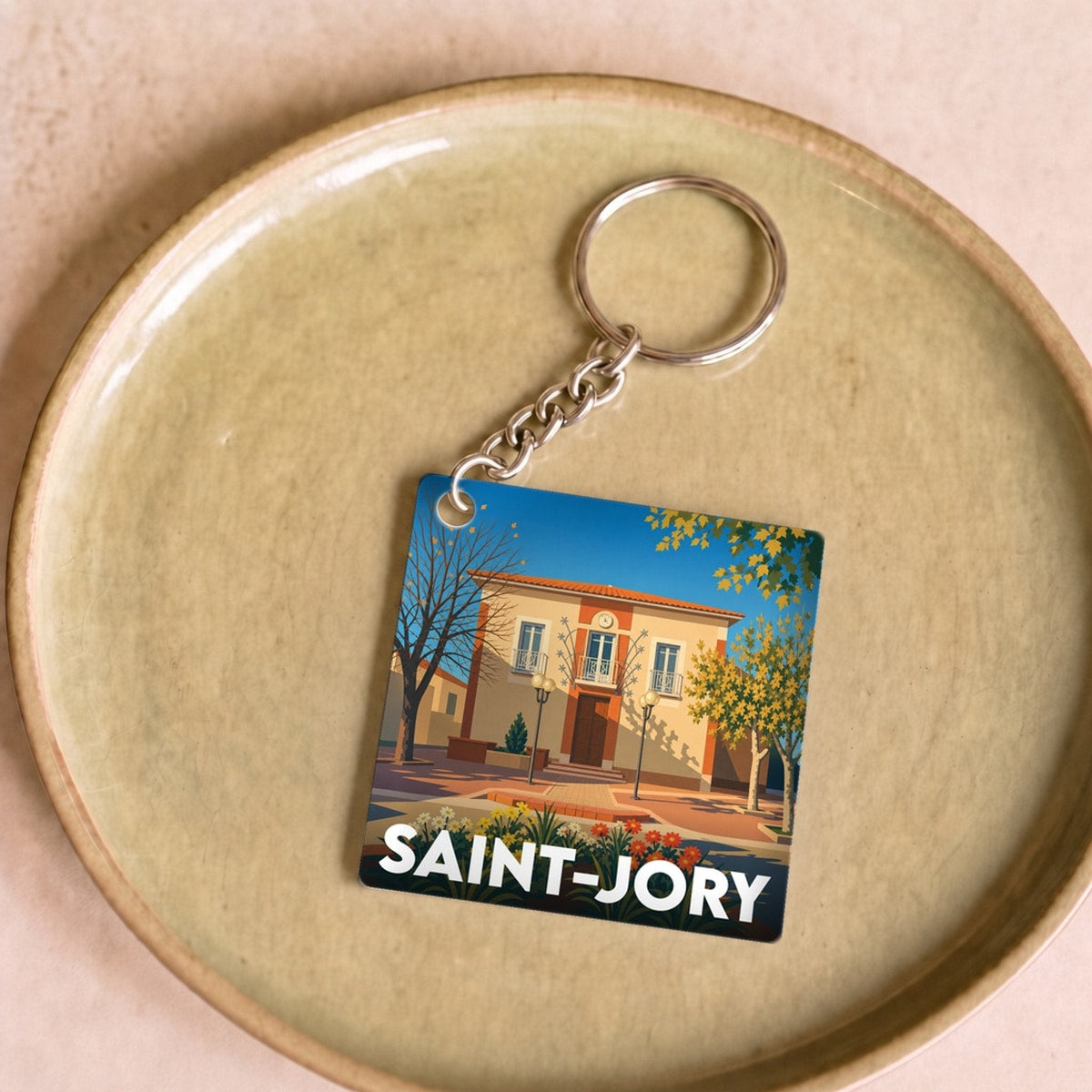 Porte-clés souvenir de la ville de Saint-Jory avec une illustration stylisée.