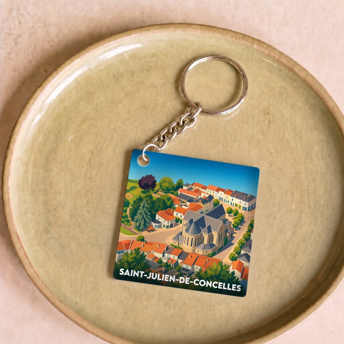 Porte-clés souvenir de la ville de Saint-Julien-de-Concelles avec une illustration stylisée en vue aérienne.