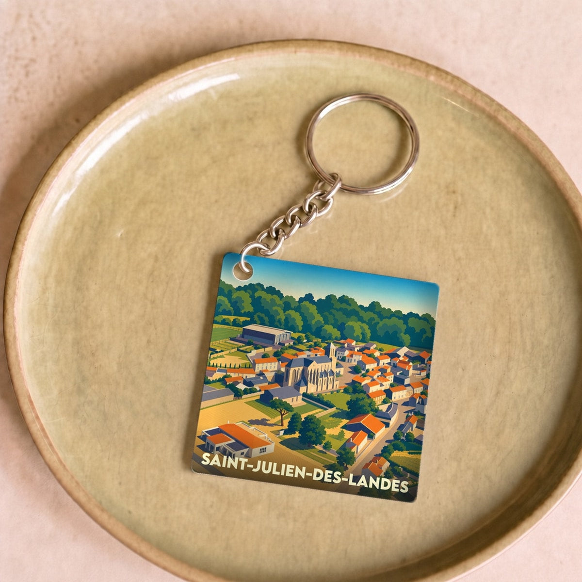 Porte-clés souvenir de la ville de Saint-Julien-des-Landes avec une illustration stylisée.