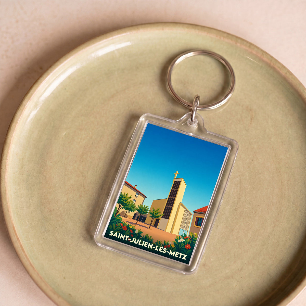 Porte-clés souvenir de la ville de Saint-Julien-lès-Metz avec une illustration stylisée de son église.