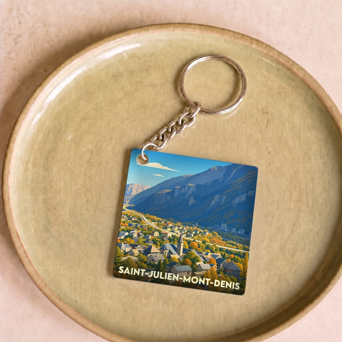 Porte-clés souvenir de la ville de Saint-Julien-Mont-Denis avec une illustration stylisée.