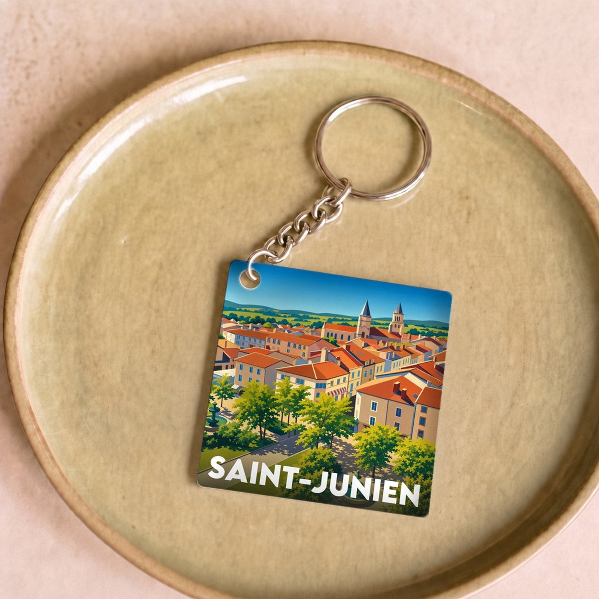 Porte-clés souvenir de la ville de Saint-Junien avec une illustration stylisée.