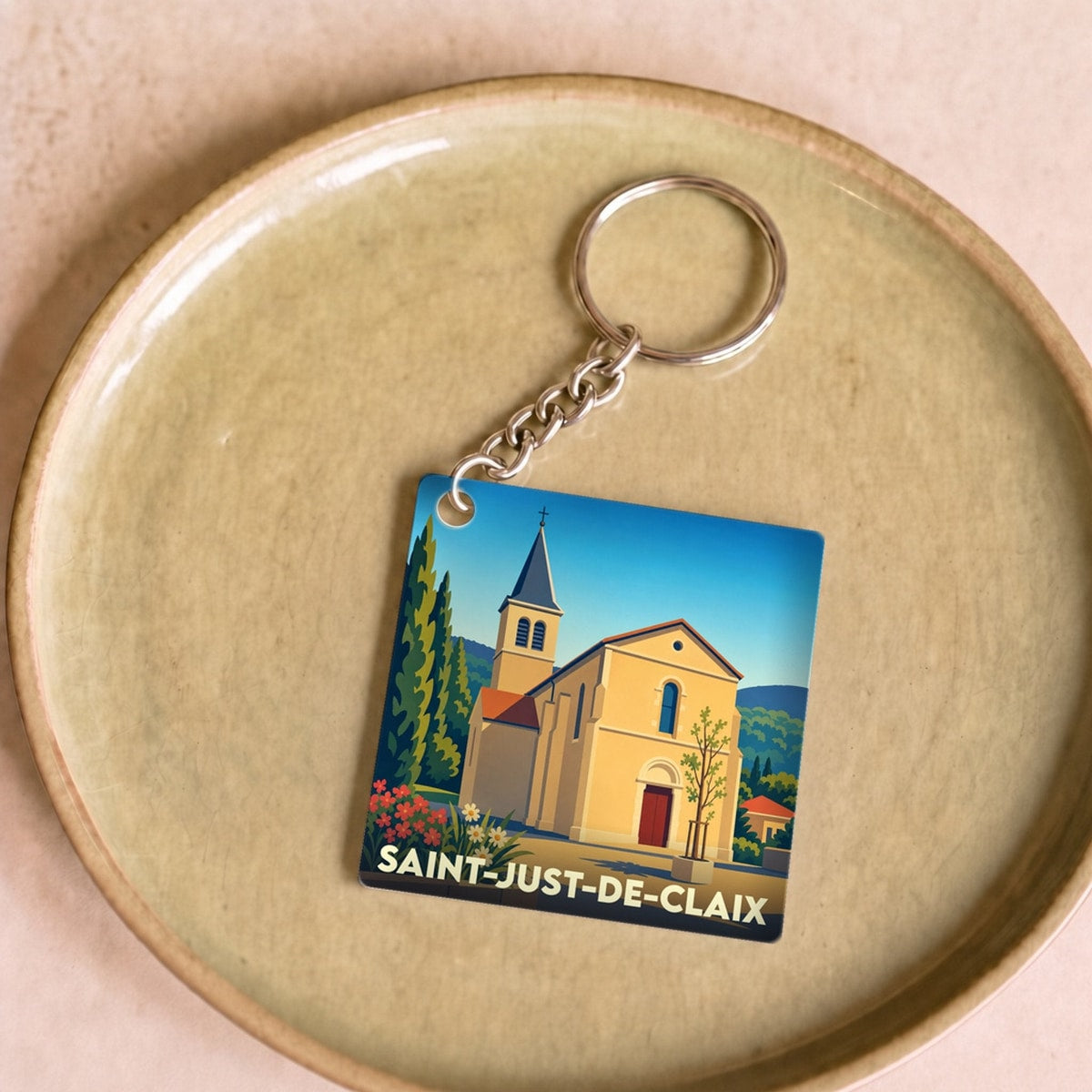 Porte-clés souvenir de la ville de Saint-Just-de-Claix avec une illustration stylisée de son église.