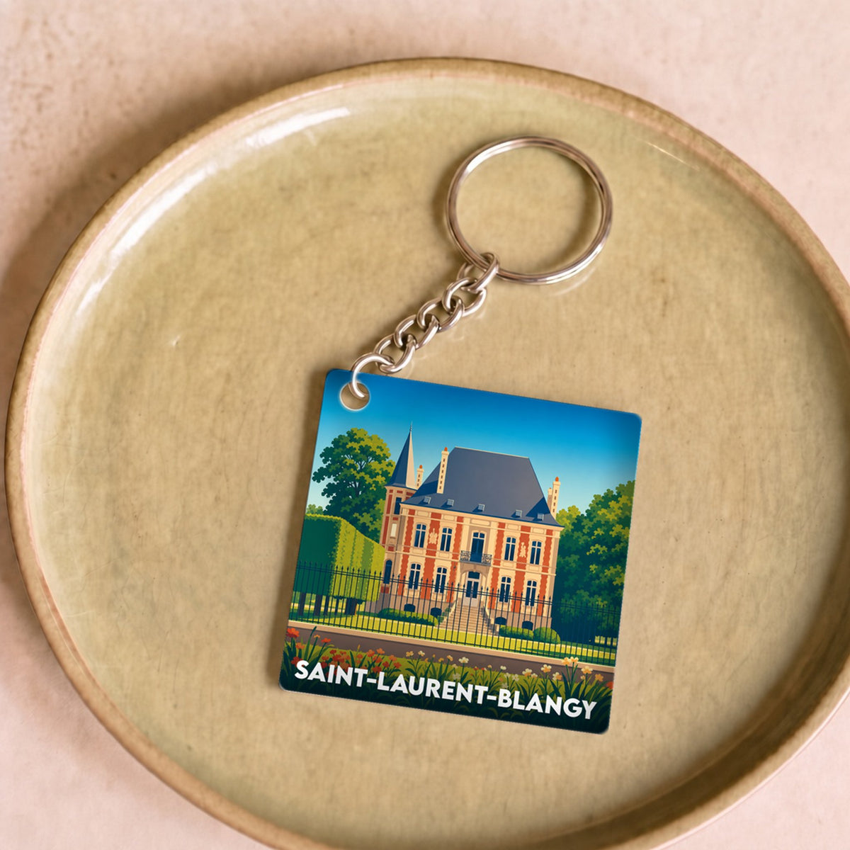 Porte-clés souvenir de la ville de Saint-Laurent-Blangy avec une illustration stylisée.