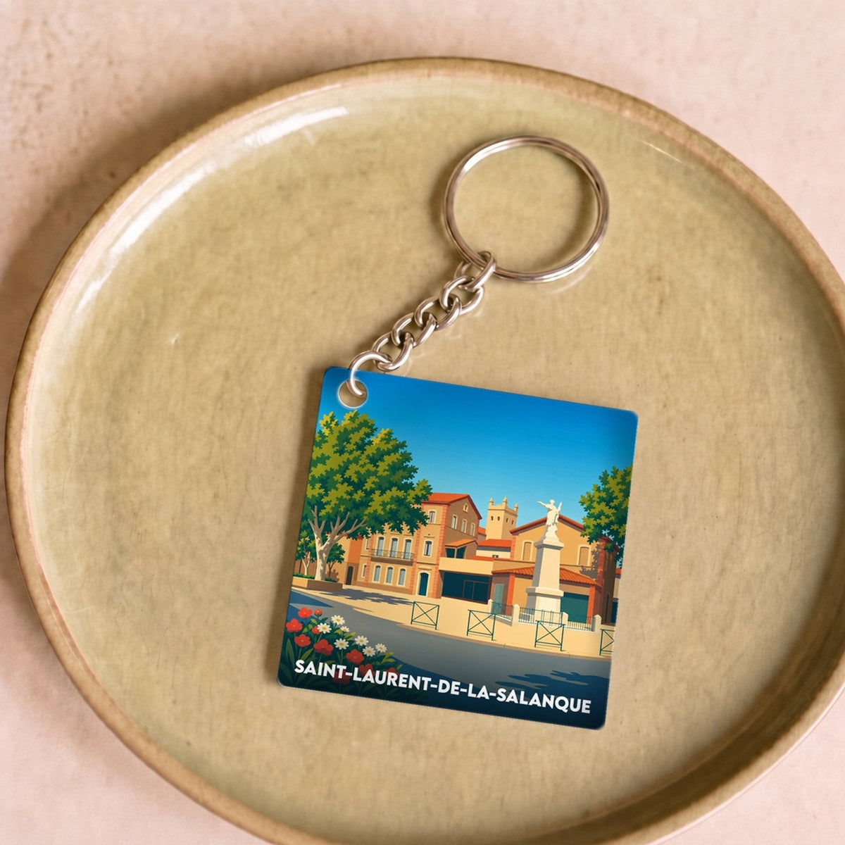 Porte-clés souvenir de la ville de Saint-Laurent-de-la-Salanque avec une illustration stylisée.