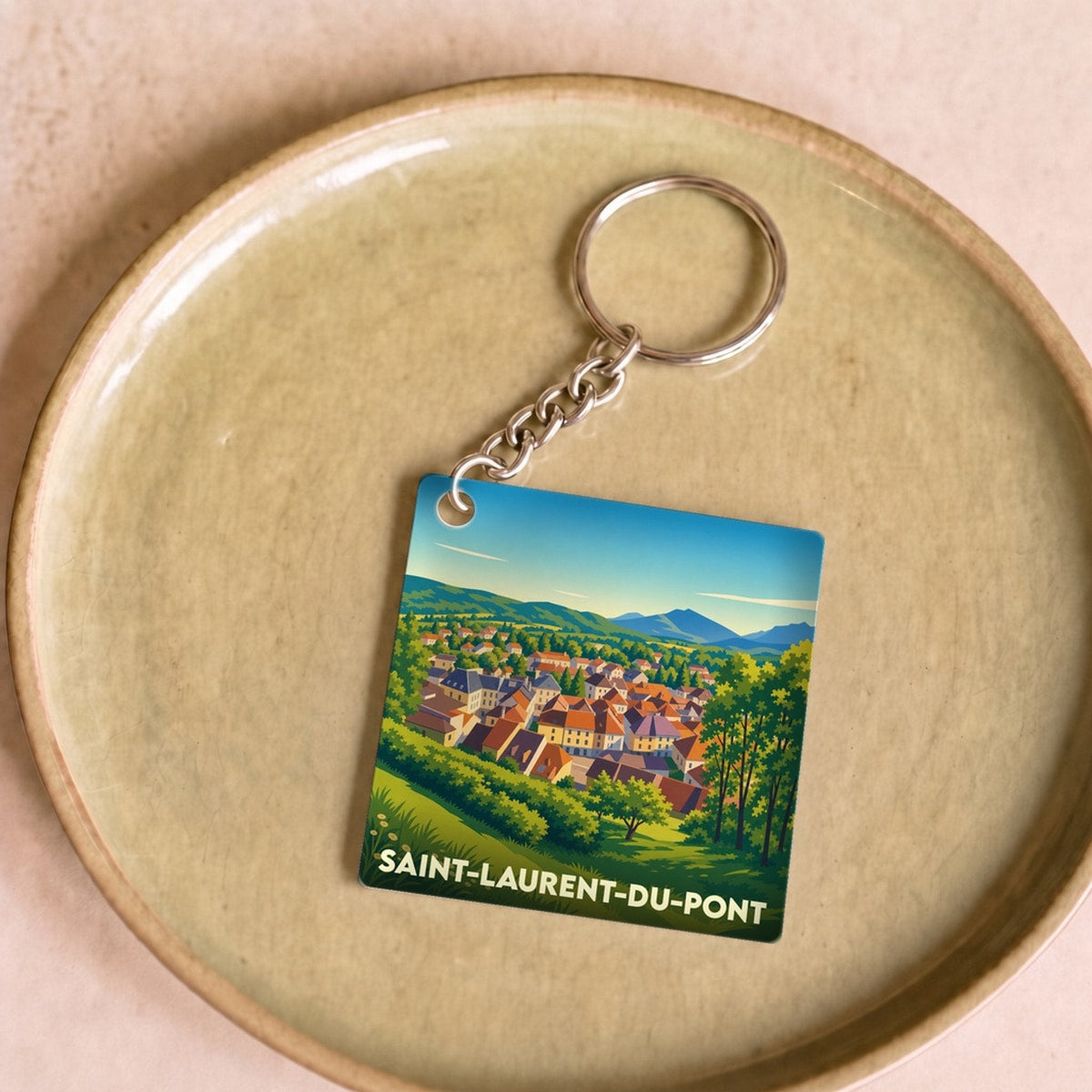 Porte-clés souvenir de la ville de Saint-Laurent-du-Pont avec une illustration stylisée.