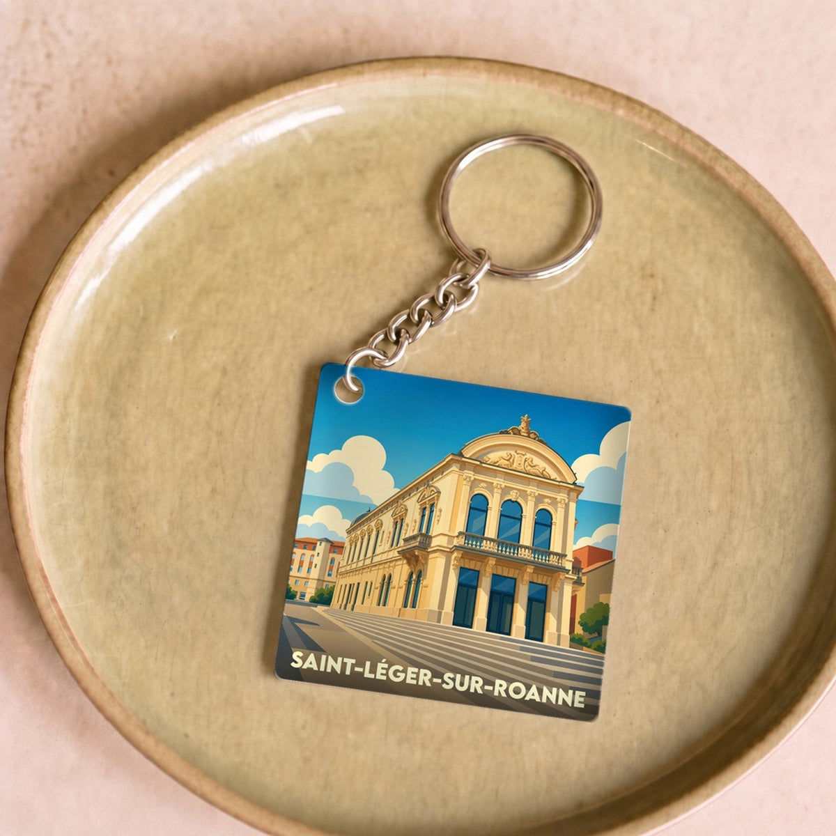 Porte-clés souvenir de la ville de Saint-Léger-sur-Roanne avec une illustration stylisée.