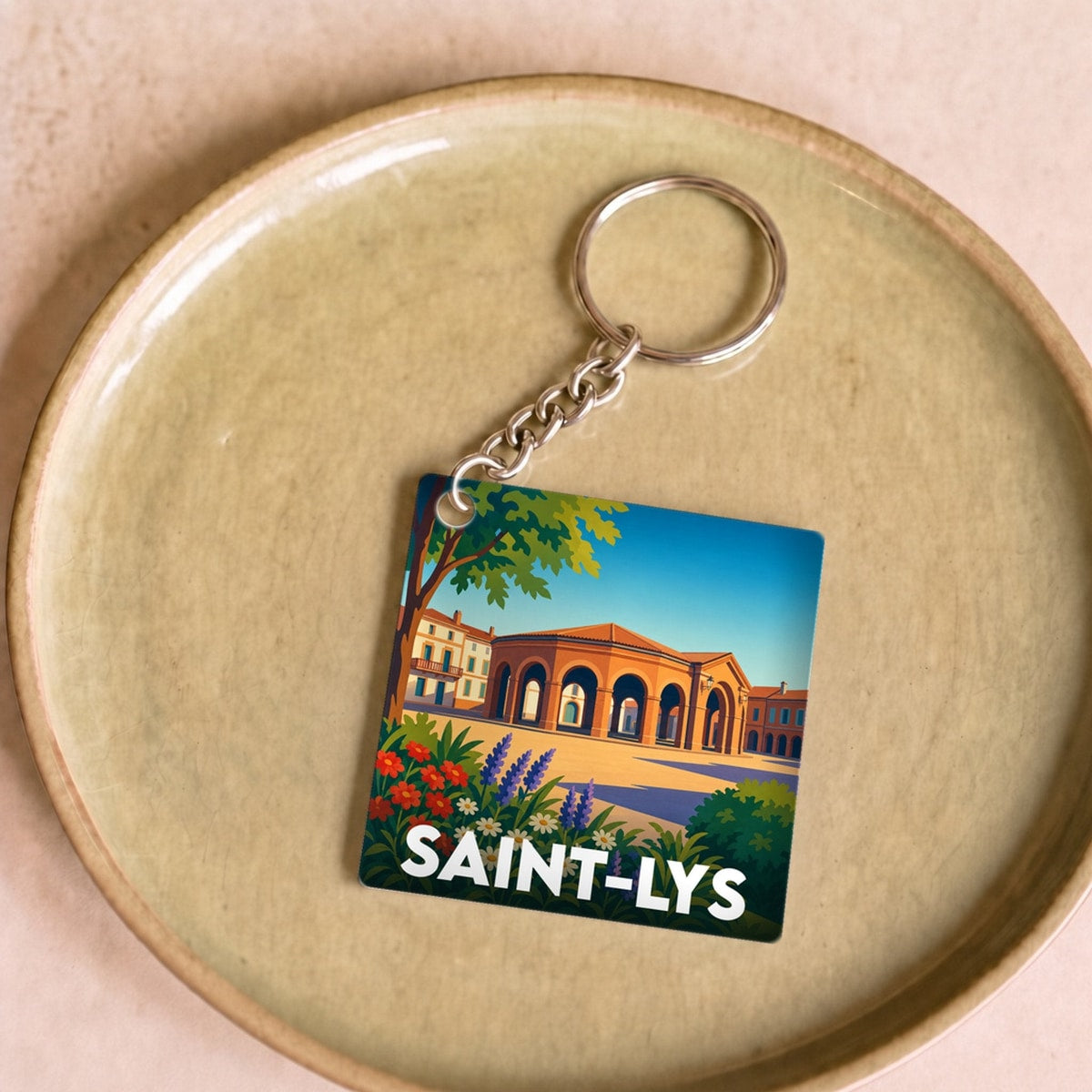 Porte-clés souvenir de la ville de Saint-Lys avec une illustration colorée et stylisée.