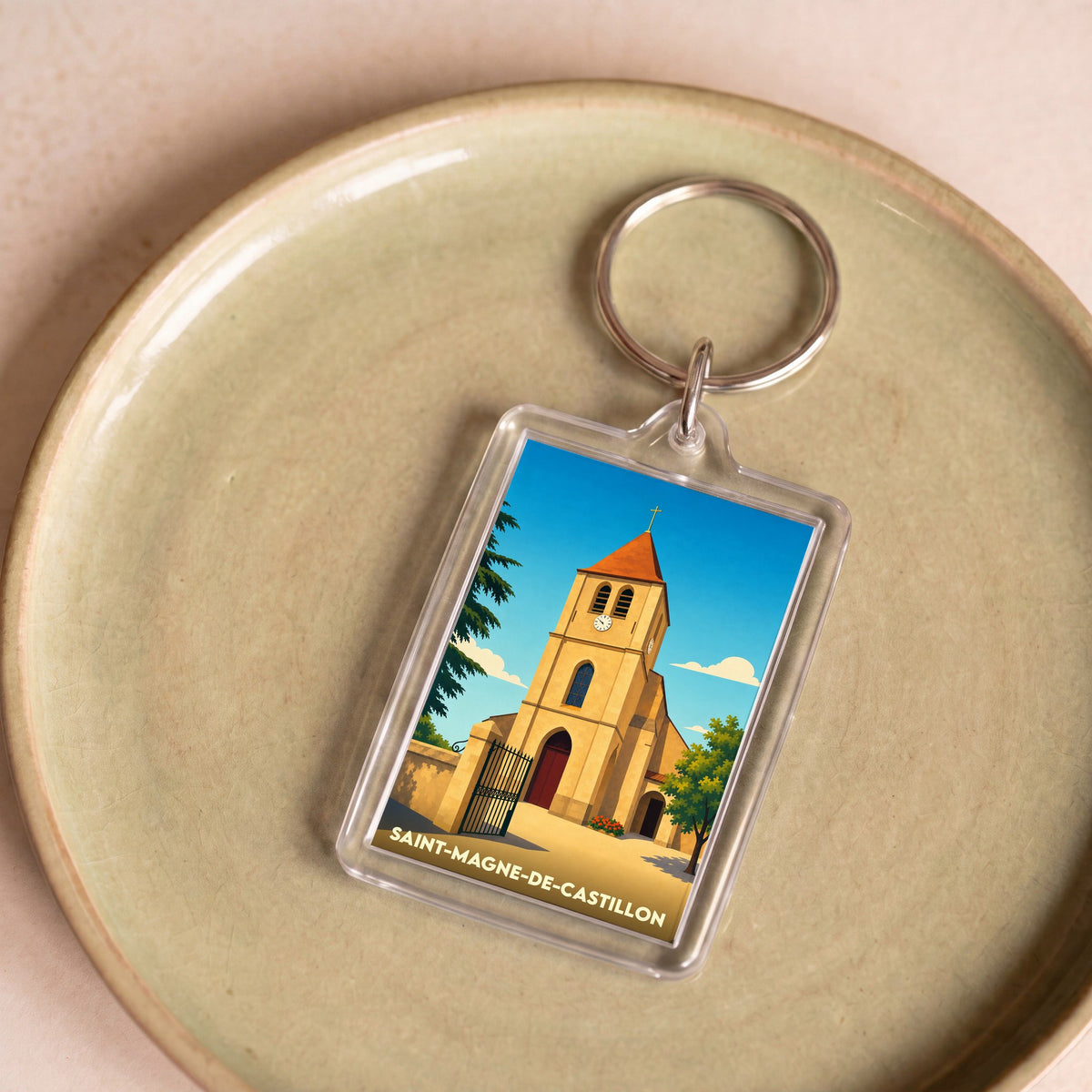 Porte-clés souvenir de la ville de Saint-Magne-de-Castillon avec une illustration stylisée de son église.