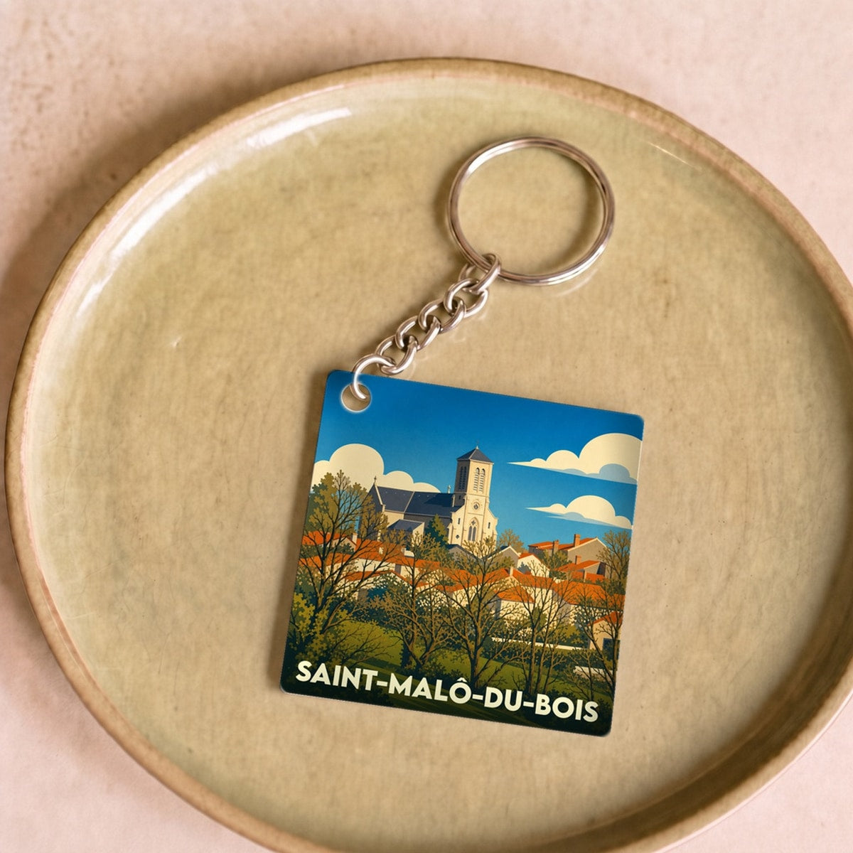 Porte-clés souvenir de la ville de Saint-Malô-du-Bois avec une illustration stylisée.