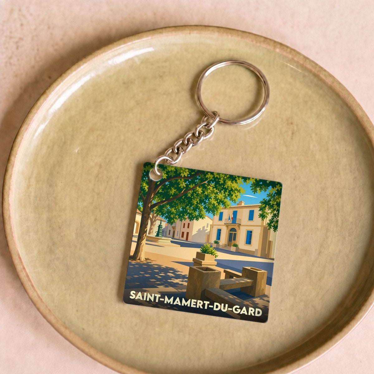 Porte-clés souvenir de la ville de Saint-Mamert-du-Gard avec une illustration stylisée.